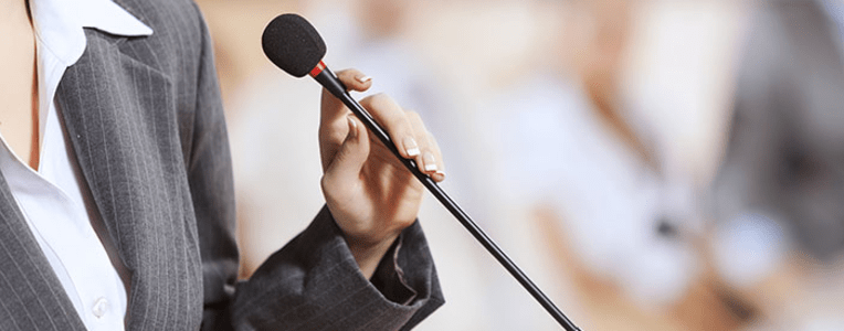 business woman speaking into a microphone