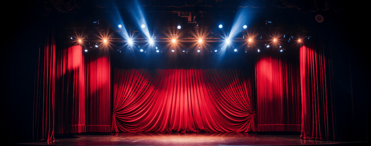 Empty stage with bright lights and red curtains
