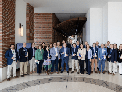 Group of professionals holding awards