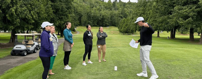 ladies on a golf course with an instructor