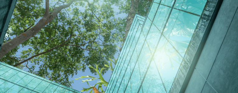 Eco-friendly building in the modern city. Sustainable glass office building with trees for reducing heat and carbon dioxide. Office building with green environment. Corporate building reduce CO2.