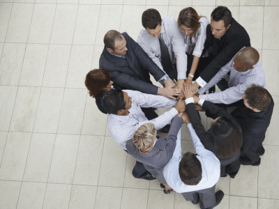 Top view of successful businesspeople putting their hands together