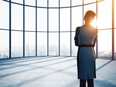 businesswoman thinking in office and looking to window