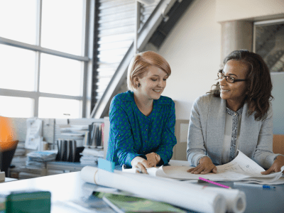 woman mentoring using blueprints