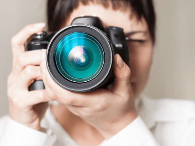 Pretty woman is a professional photographer with dslr camera