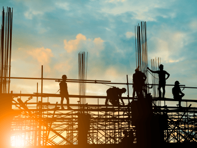 Silhouette of engineer and construction team working safely on scaffolding on high rise building. over blurred background sunset pastel for industry background with Light fair