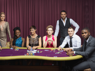 Well-dressed group at poker table in casino