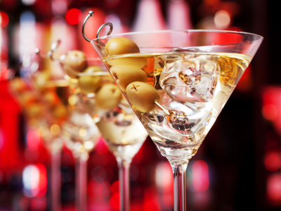 Several glasses of famous cocktail Martini, shot at a bar with shallow depth of field
Ingredients:
55 ml gin
15 ml dry vermouth
olives to garnish