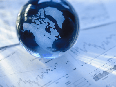 glass-globe-on-financial_papers-blue