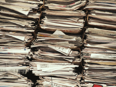 Several Stacks of newspapers lined up against a wall