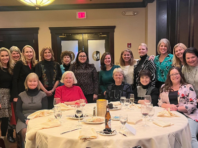 CREW St. Louis Legacy members posing at a banquet table