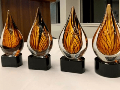 four amber glass trophies