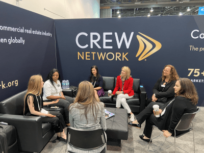 Women connecting at CREW Network ICSC  2022 booth