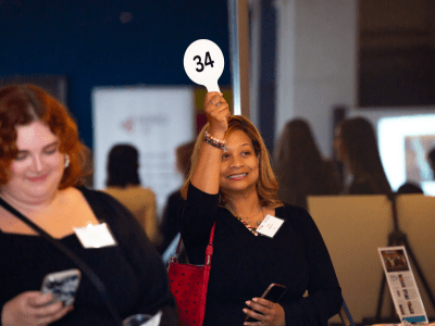 woman-holding-up-auction-paddle