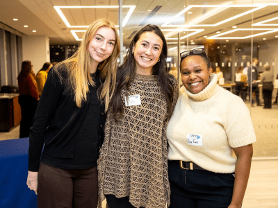 three diverse ladies standing in front of mirrored wall