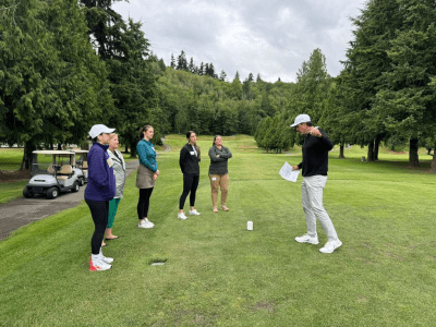 ladies on a golf course with an instructor