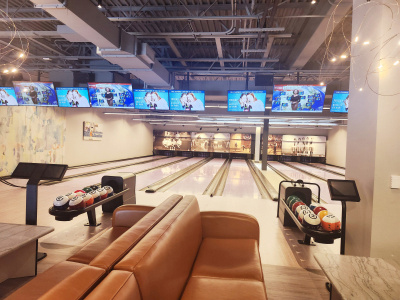 bowling alley with bowling balls and lanes and sreens for scores