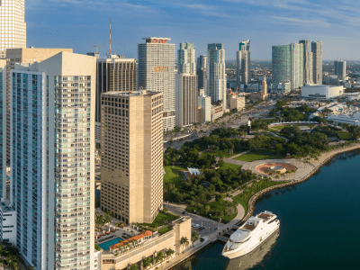 Downtown city skyline and calm ocean waterfront and Bayfront Park of Miami at sunrise, Florida, United States.