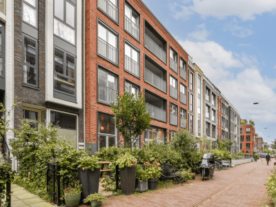 Contemporary residential buildings showcase sleek designs and harmonious layouts, surrounded by lush greenery and walkable paths, emphasizing urban living.