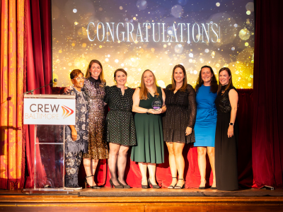 CREWBaltimore Beacon Award Winners smiling and holding awards on a stage