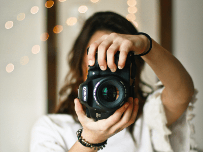 woman-standing-holding-camera