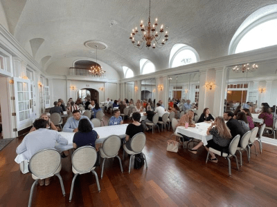 banquet room full of people at tables talking and making connections