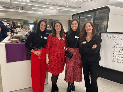 Four women at a holiday party.