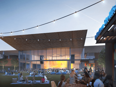 people sitting outside on lawn at an amphitheater