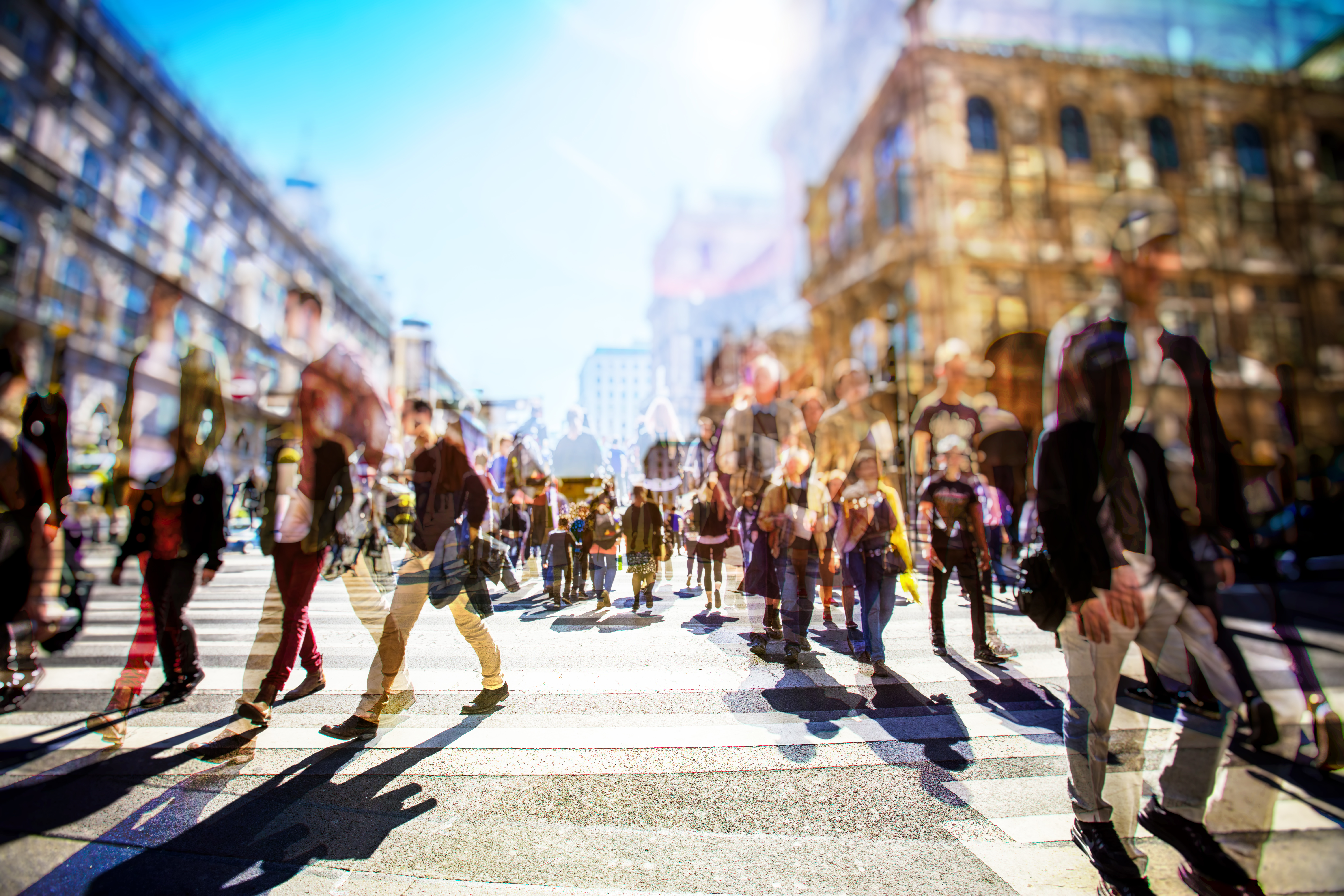 blurred photo of a crowd of people walking on a busy city street
