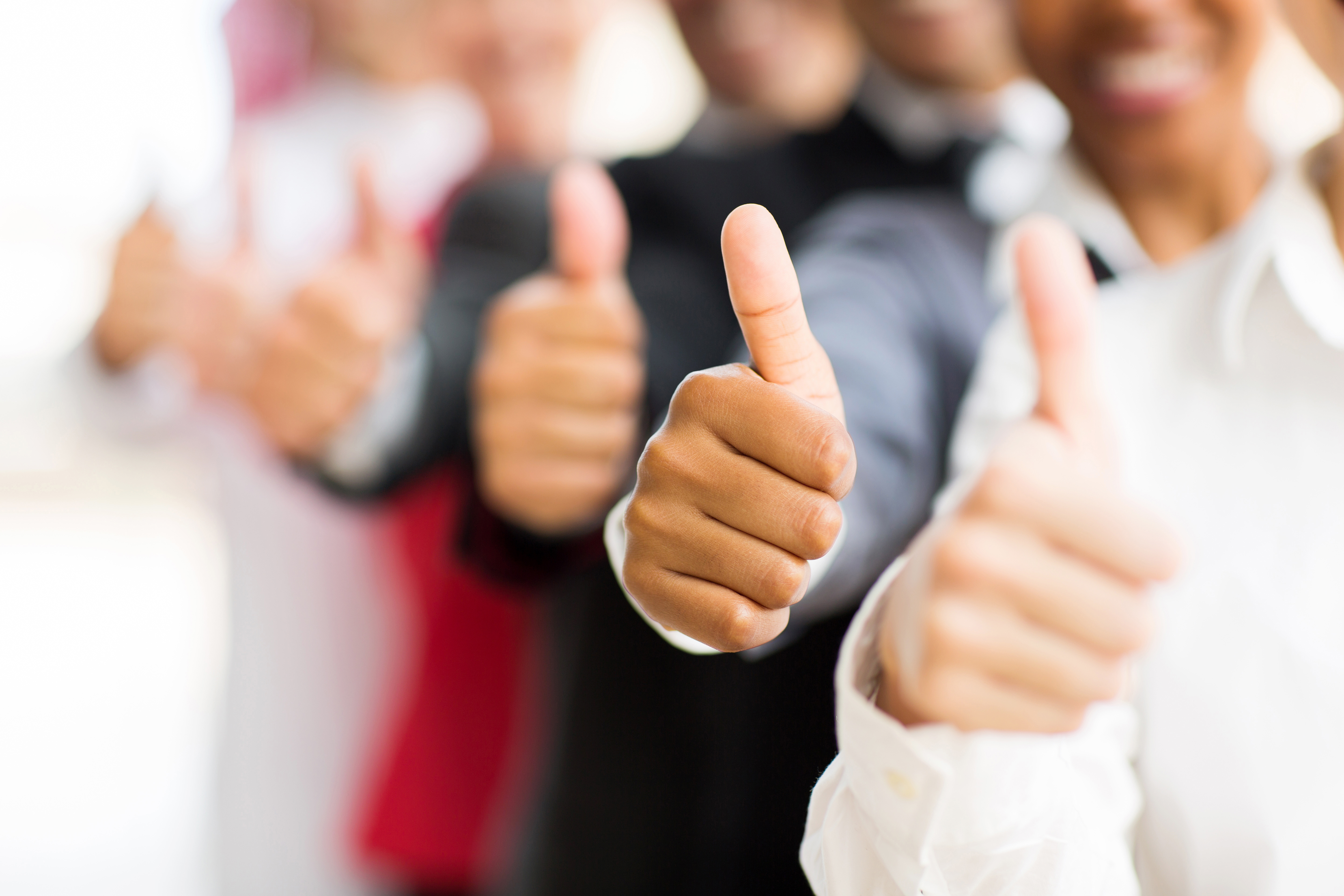 closeup portrait of business people giving thumbs up