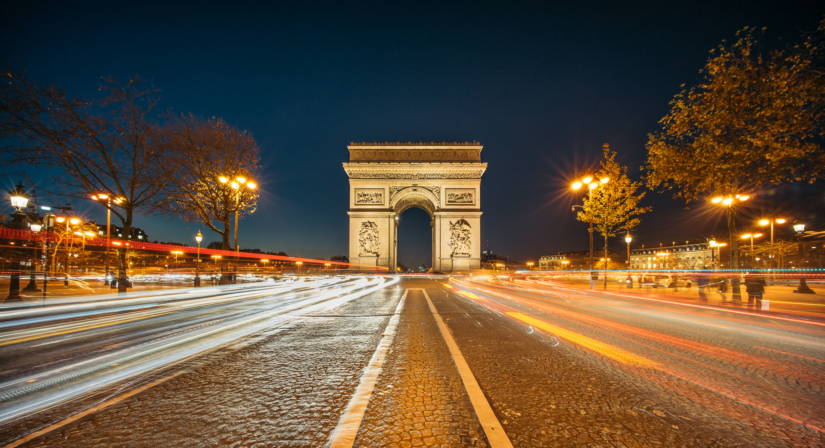 The Arc de Triomphe de l'Etoile (Triumphal Arch of the Star) at Night. It is one of the most famous monuments in Paris, standing at the western end of the Champs-Elyseees.