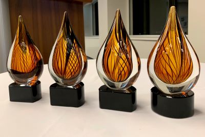 four amber glass trophies