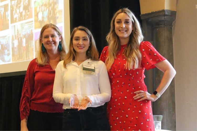 three women posing at leadership awards event