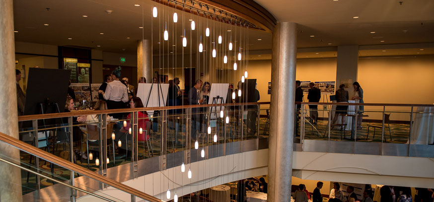 attendees mingling across the balcony in a hotel conference room