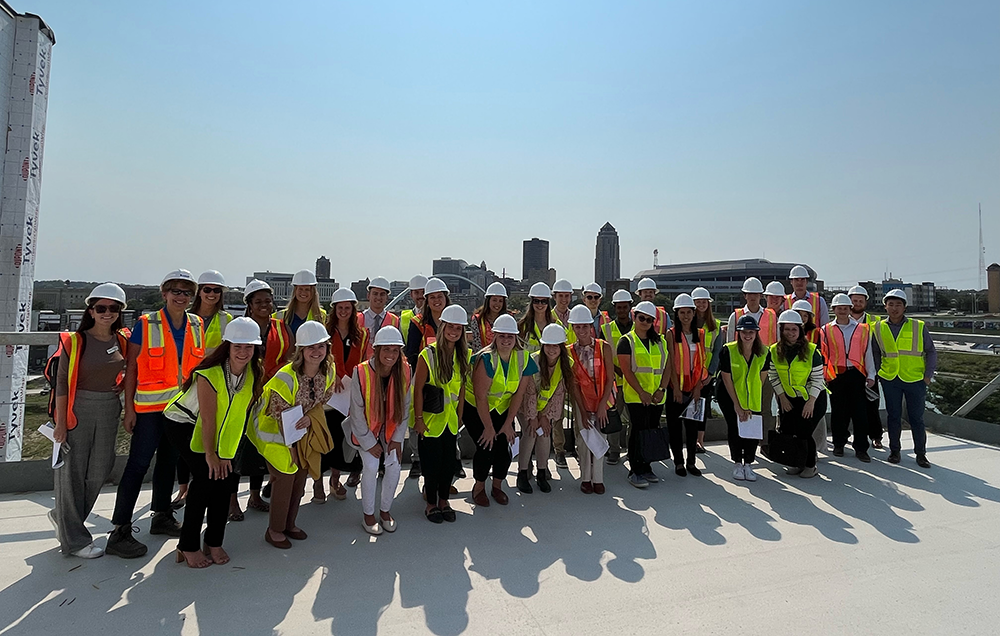 students in high visibility jackets and hard hats on a job site