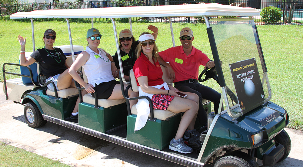 Orlando CREW Golf event passengers traveling in a golf cart